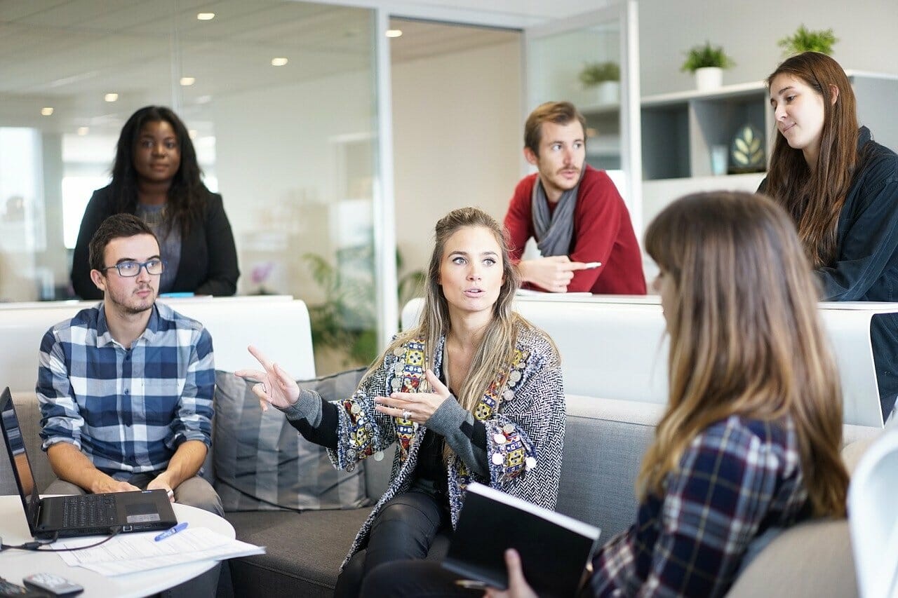 Work team having a discussion, lead by female.