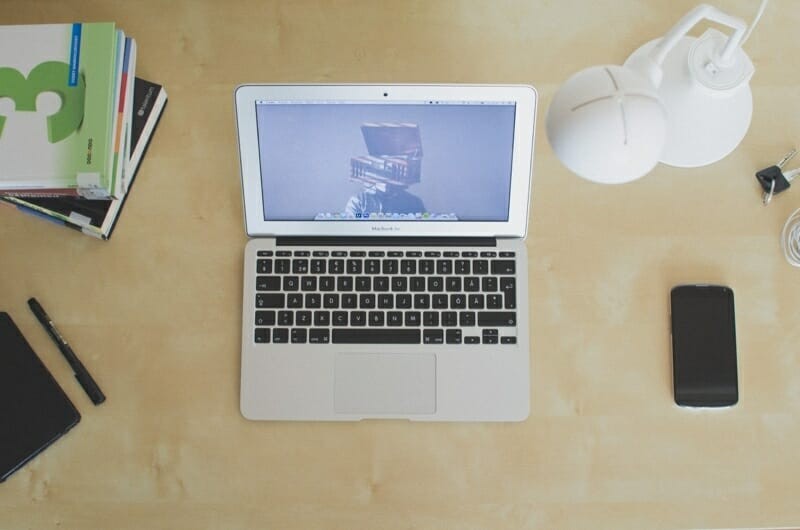 white laptop on wooden desk